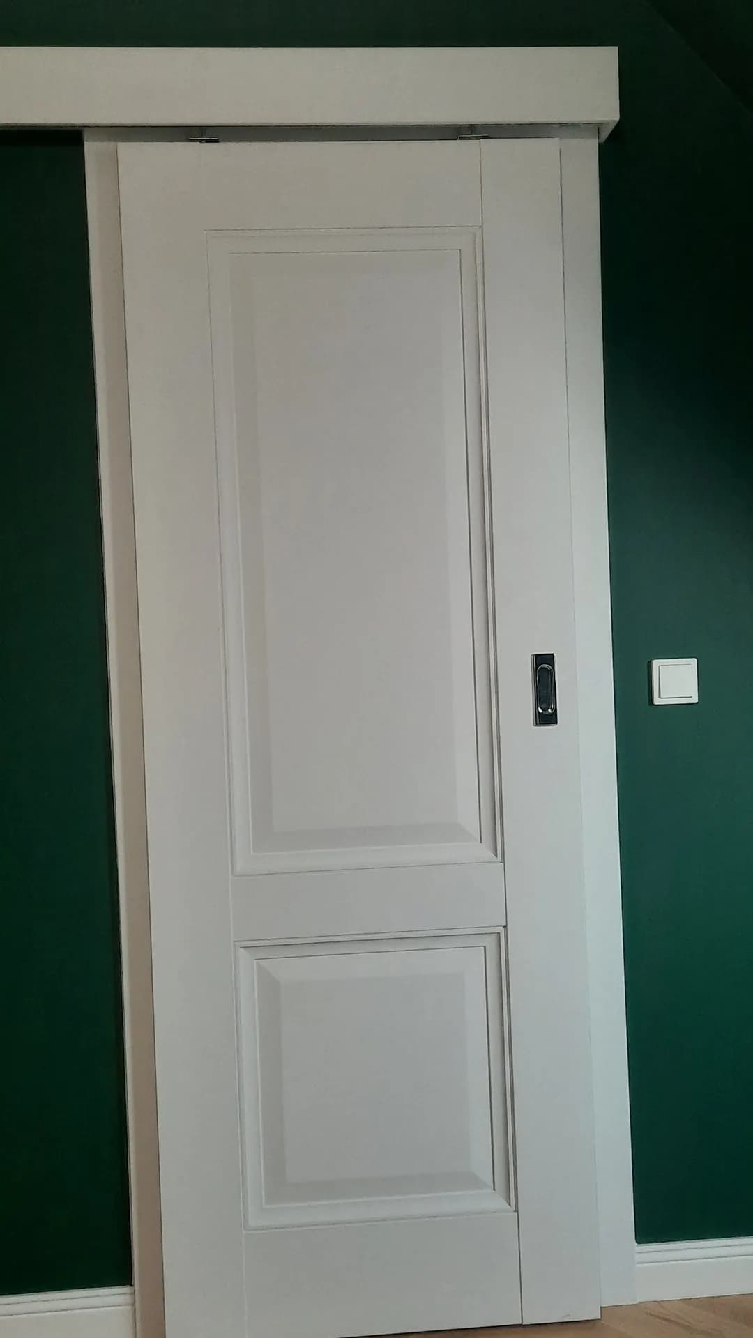 Białe drzwi wewnętrzne pod skosem, ściana w kolorze butelkowej zieleni — realizacja MP Studio, Pisz i okolice